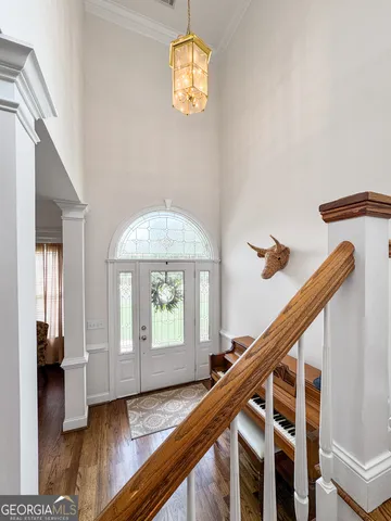 a view of entryway and hall with wooden floor