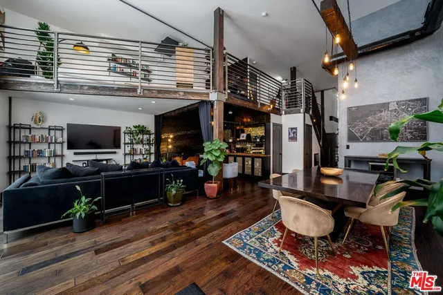 a living room with furniture a flat screen tv and a table
