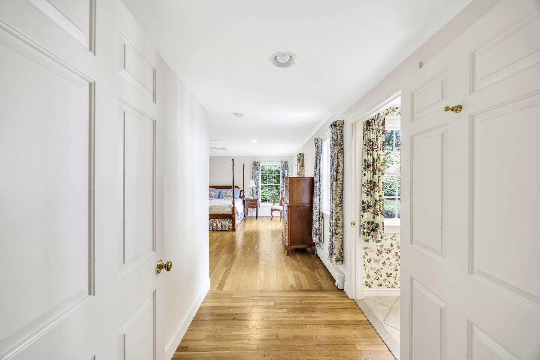 473 Davisville Road East Falmouth, MA 02536 - Photo 14 of 41 a view of a hallway with wooden floor and furniture