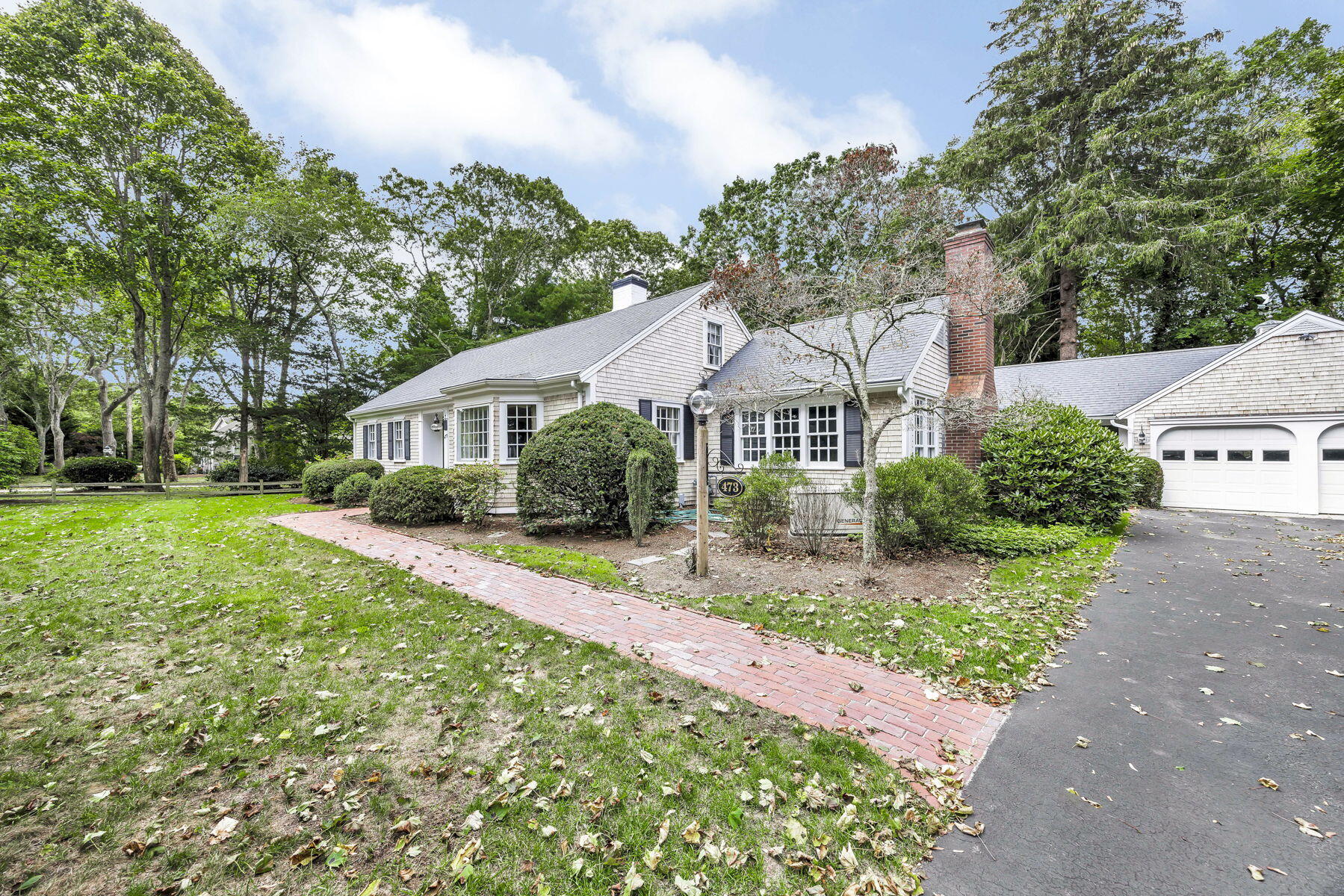 473 Davisville Road East Falmouth, MA 02536 - Photo 3 of 41 a front view of a house with a yard and green space