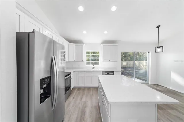 a kitchen with a wooden floor and window