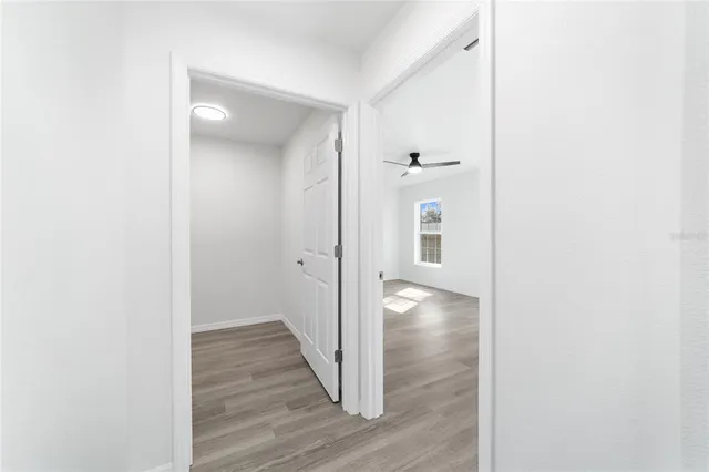 a view of empty room with wooden floor