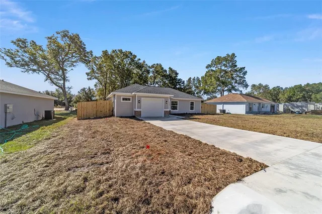 a front view of a house with a yard and a garage