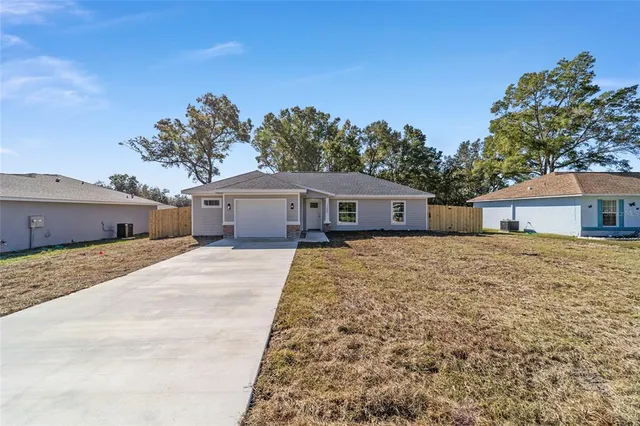 a front view of a house with a yard and a garage