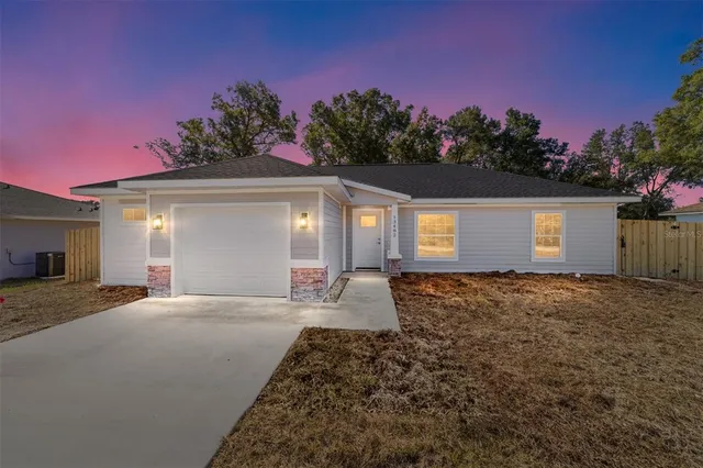 a view of a house with a yard and garage