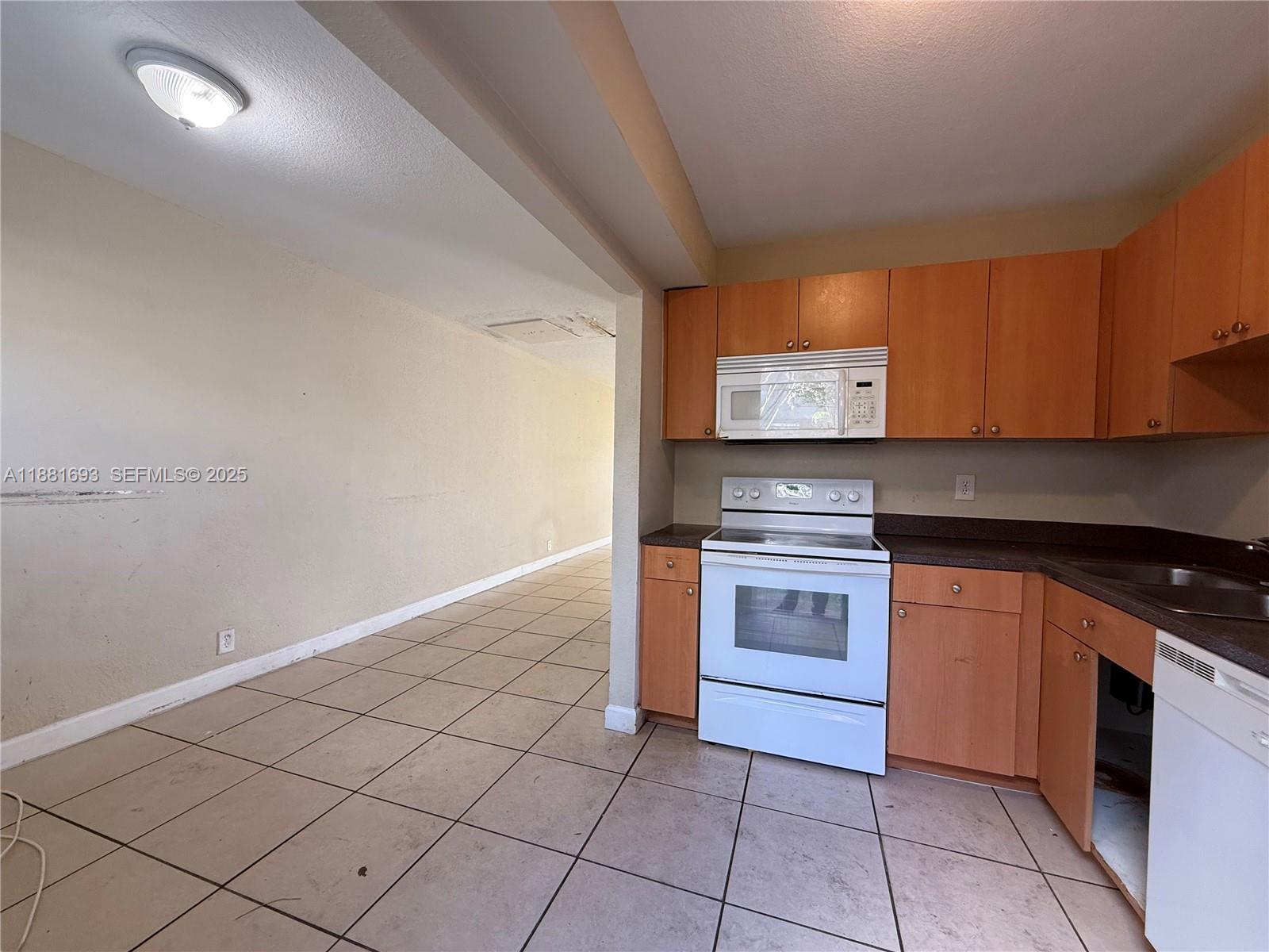 4625 Northwest 9th Drive, Unit 4625 Plantation, FL 33317 - Photo 12 of 26 a kitchen with granite countertop a stove and a sink
