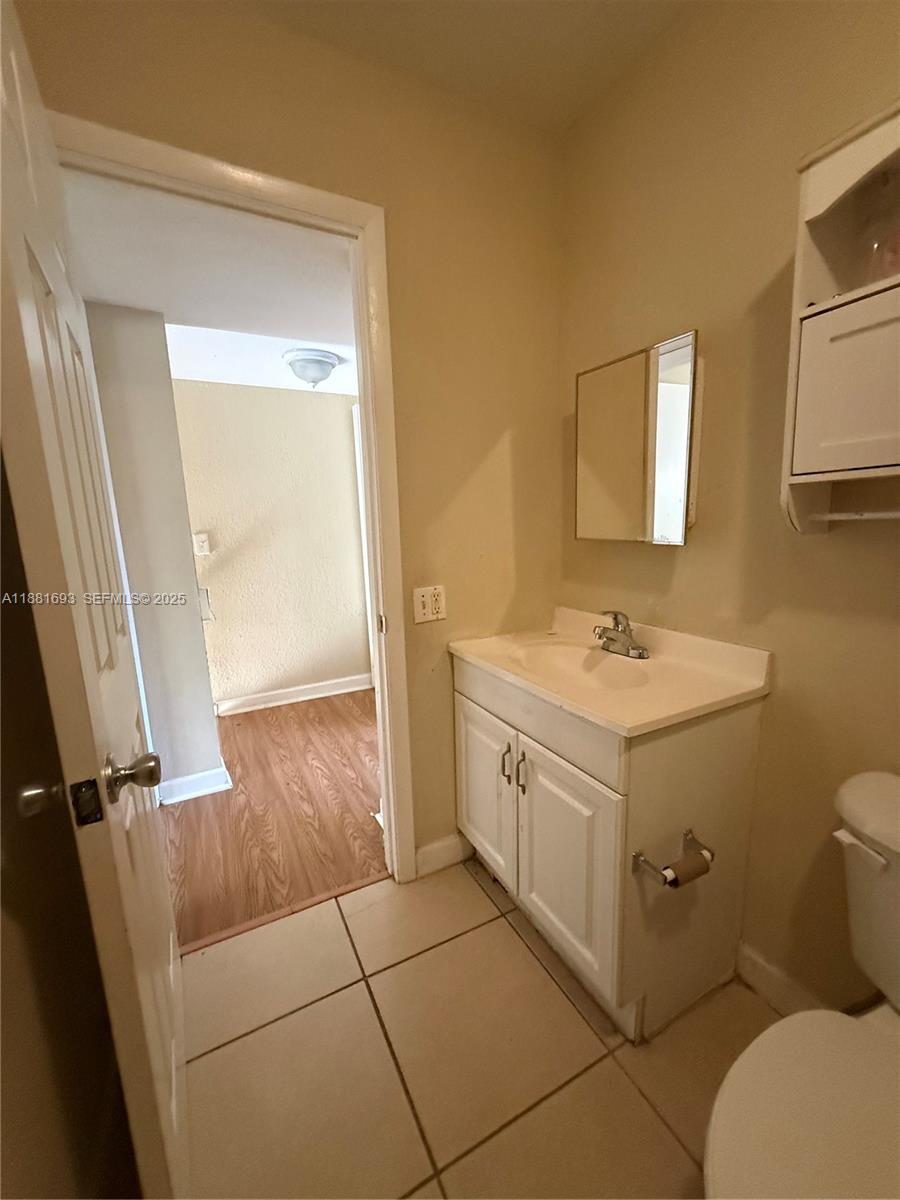 4625 Northwest 9th Drive, Unit 4625 Plantation, FL 33317 - Photo 15 of 26 a bathroom with a sink mirror vanity and toilet