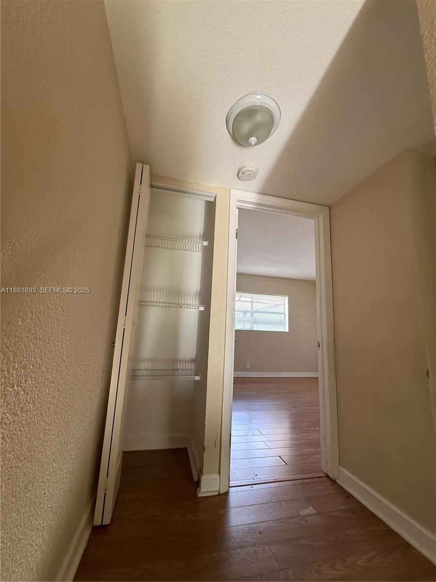 4625 Northwest 9th Drive, Unit 4625 Plantation, FL 33317 - Photo 17 of 26 an empty room with wooden floor