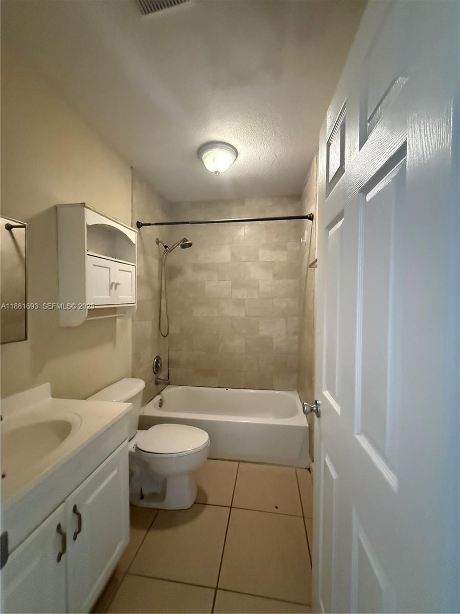 4625 Northwest 9th Drive, Unit 4625 Plantation, FL 33317 - Photo 19 of 26 a bathroom with a granite countertop sink a toilet and shower