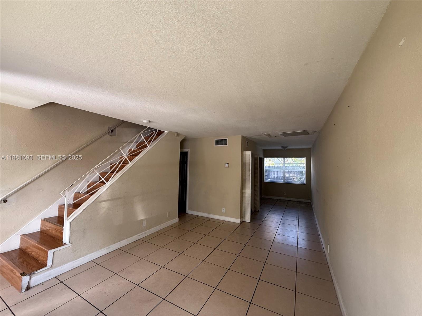 4625 Northwest 9th Drive, Unit 4625 Plantation, FL 33317 - Photo 2 of 26 a view of a hallway with stairs