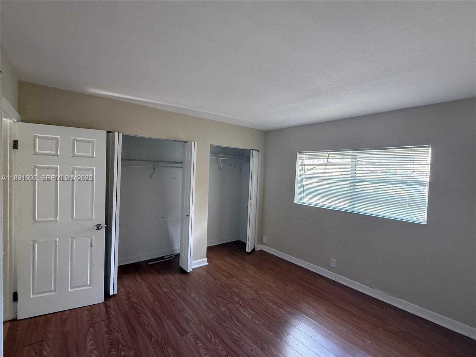 4625 Northwest 9th Drive, Unit 4625 Plantation, FL 33317 - Photo 22 of 26 an empty room with wooden floor and windows