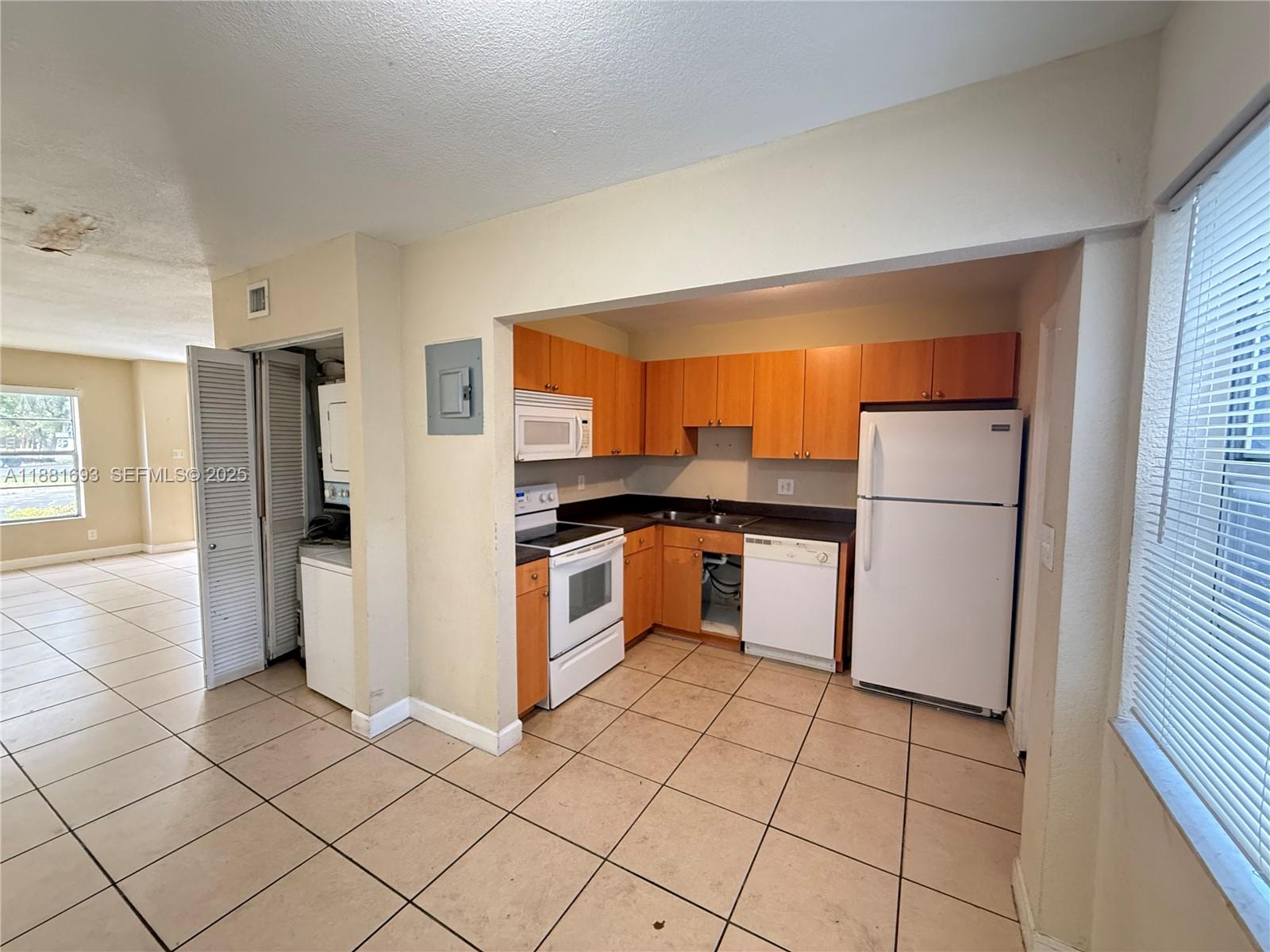 4625 Northwest 9th Drive, Unit 4625 Plantation, FL 33317 - Photo 10 of 26 a kitchen with granite countertop a refrigerator and a stove top oven