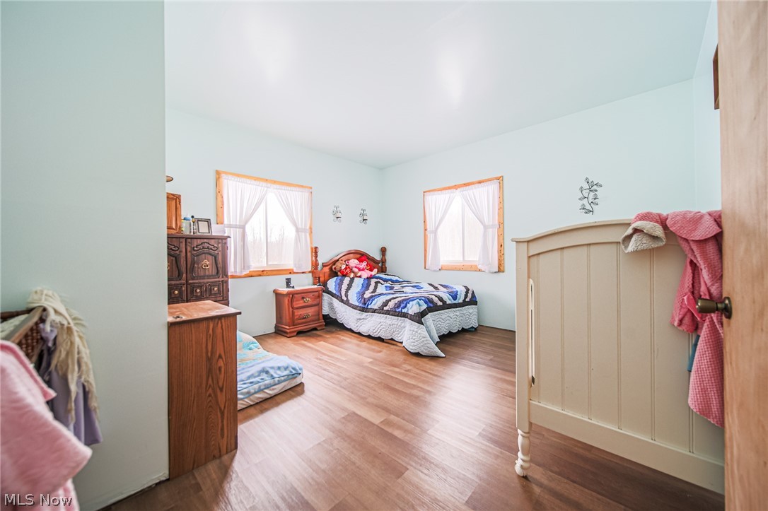 3542 Mann Road Andover, OH 44003 - Photo 11 of 42 Bedroom featuring wood finished floors and multiple windows
