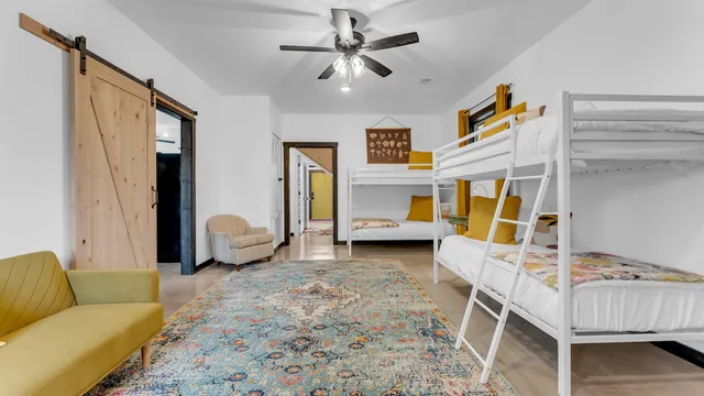 a bedroom with a bed and a chandelier