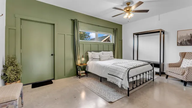 a living room with furniture a flat screen tv and kitchen view