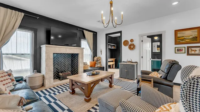 a living room with furniture fireplace and a large window