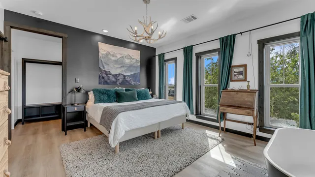 a bedroom with a large bed and a large window