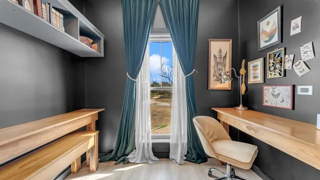 a view of a balcony with chairs and wooden floor