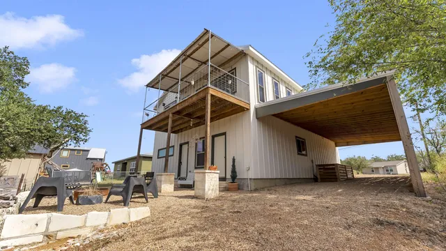 a view of a yard with wooden fence