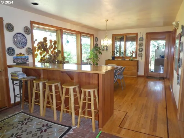 a view of a dining room with furniture wooden floor and a rug