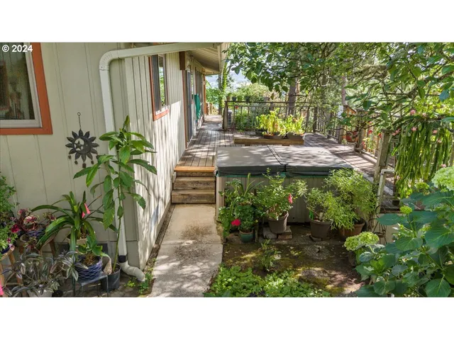 a view of a house with a small yard and sitting area