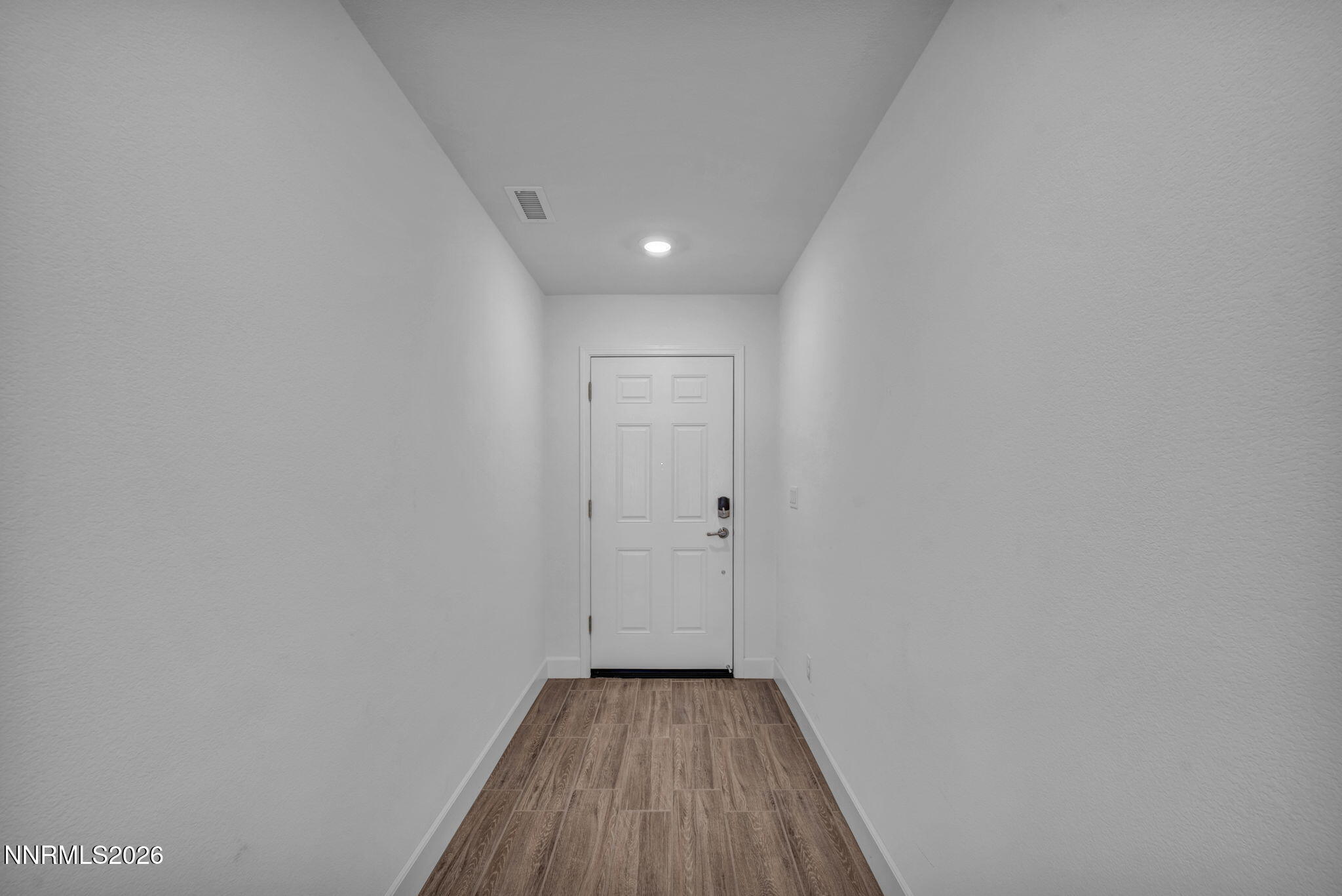 7181 Saddlehorn Road Carson City, NV 89701 - Photo 5 of 62 a view of a hallway with wooden floor