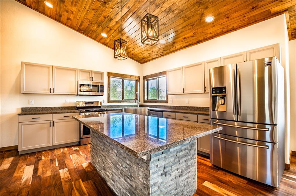 2267 High Creek Road Fairplay, CO 80440 - Photo 2 of 21 a kitchen with stainless steel appliances granite countertop a refrigerator a stove and a sink with wooden floors