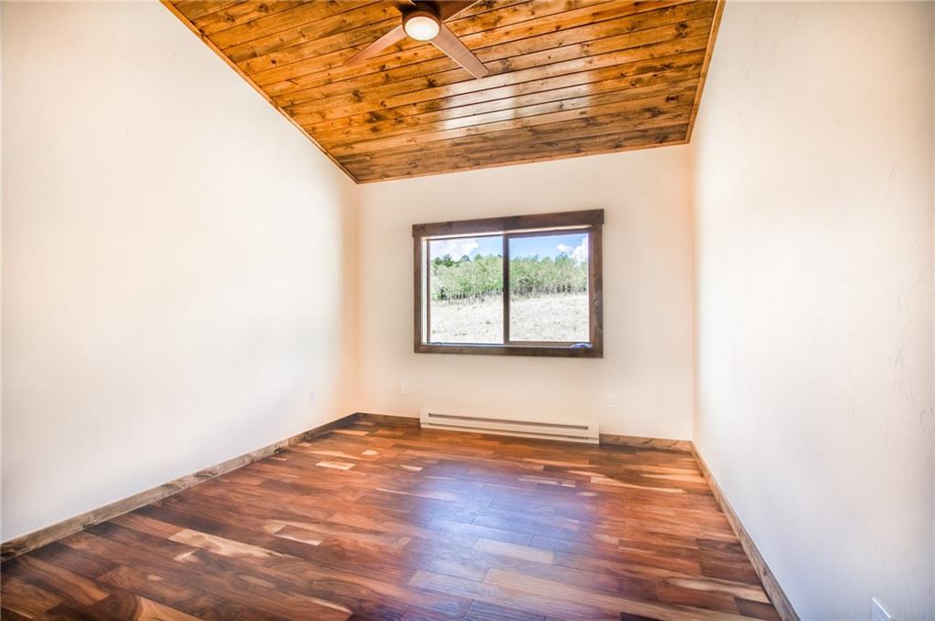 2267 High Creek Road Fairplay, CO 80440 - Photo 13 of 21 an empty room with wooden floor and windows