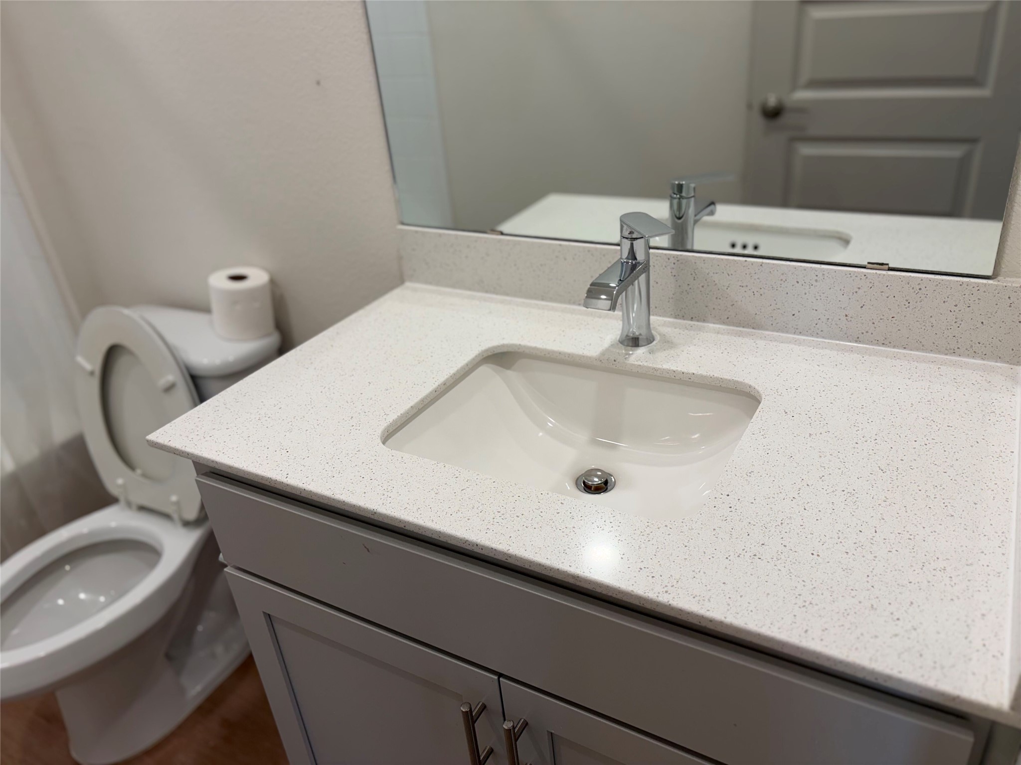 10708 Gonzales Ranger Pass Austin, TX 78754 - Photo 5 of 40 A well-appointed bathroom features a sleek vanity with a spacious counter and a modern sink, accompanied by a practical toilet.