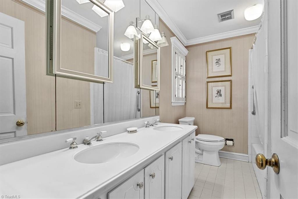952 Nottingham Road High Point, NC 27262 - Photo 26 of 47 Primary bathroom with Corian countertops and tile flooring.