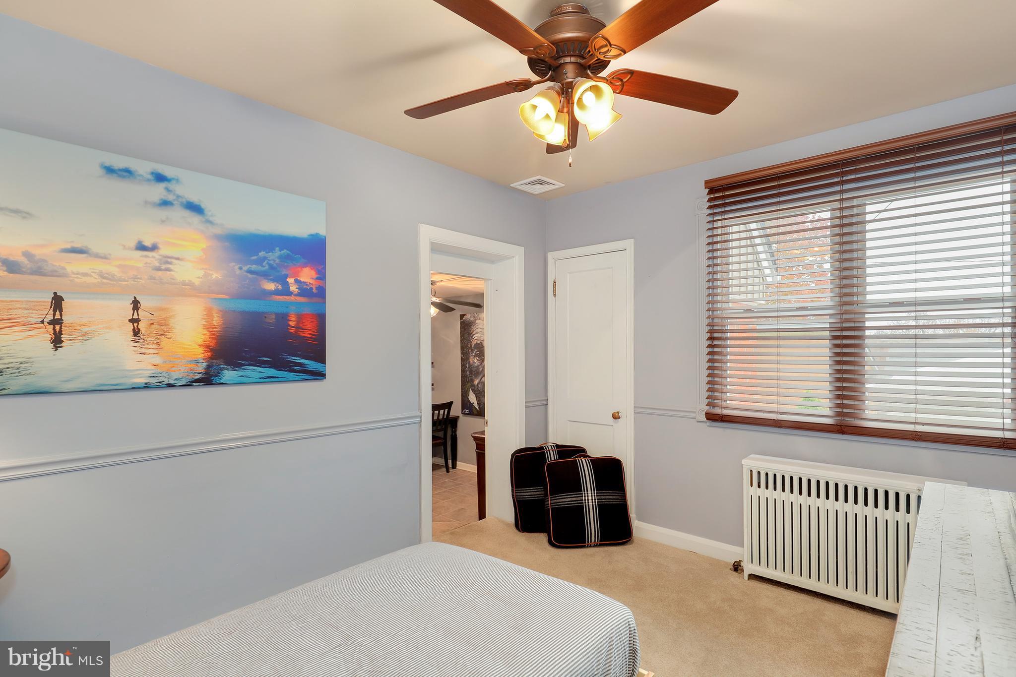 5545 Gayland Road Baltimore, MD 21227 - Photo 12 of 30 a bedroom with a bed and a chandelier