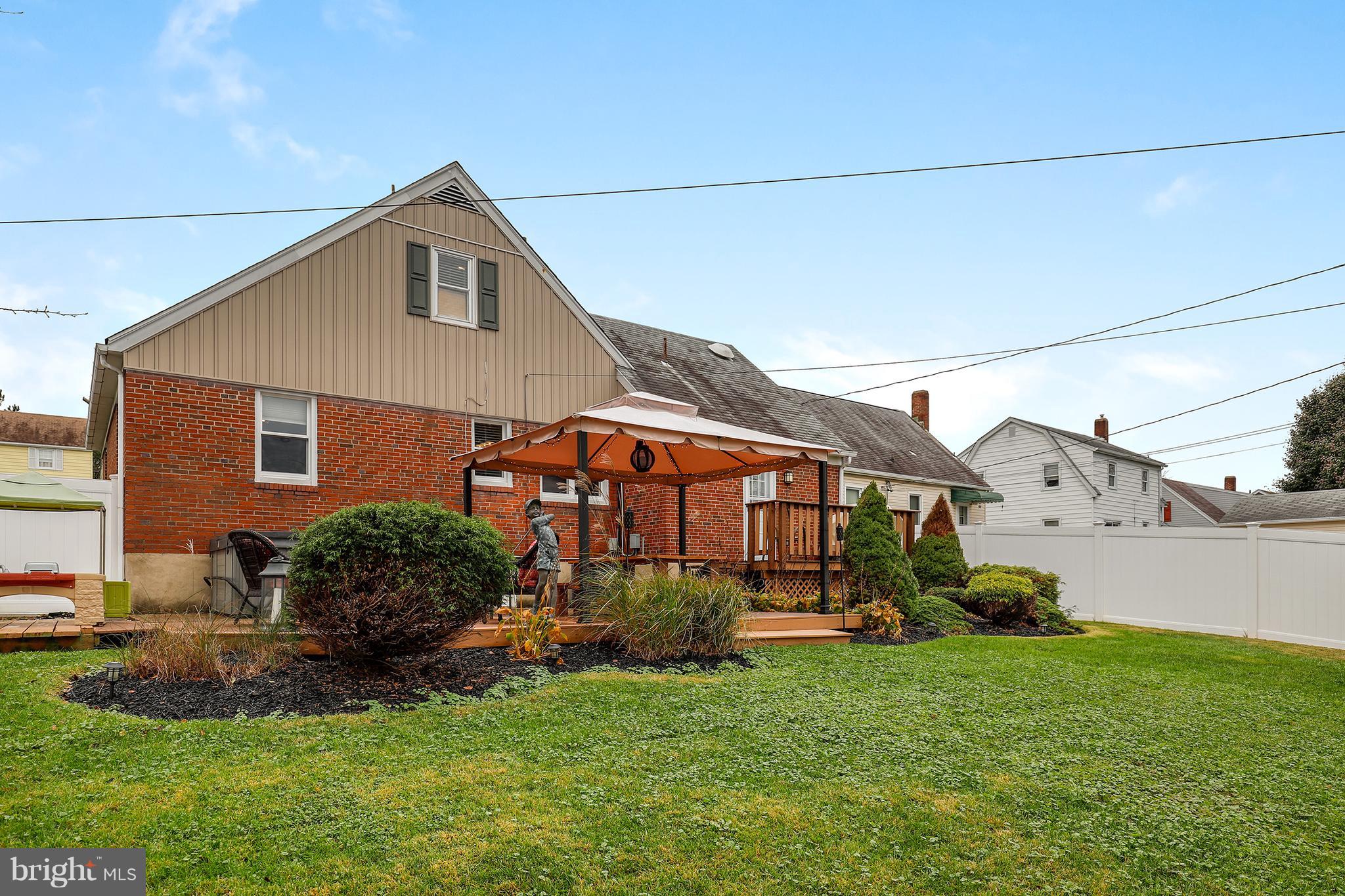 5545 Gayland Road Baltimore, MD 21227 - Photo 28 of 30 a front view of a house with a yard and garage