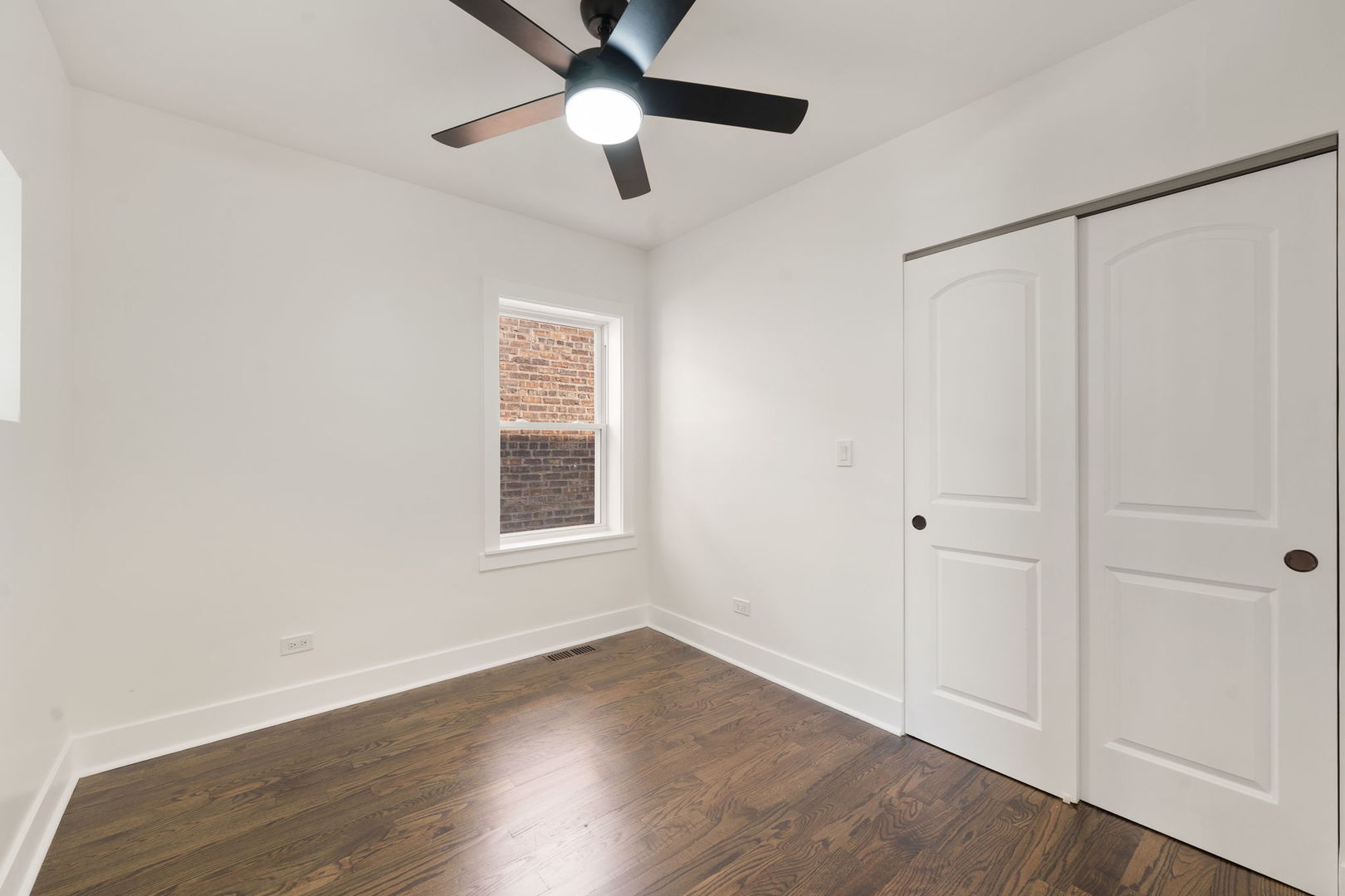 2733 Wesley Avenue Berwyn, IL 60402 - Photo 15 of 33 a view of an empty room with wooden floor and a window