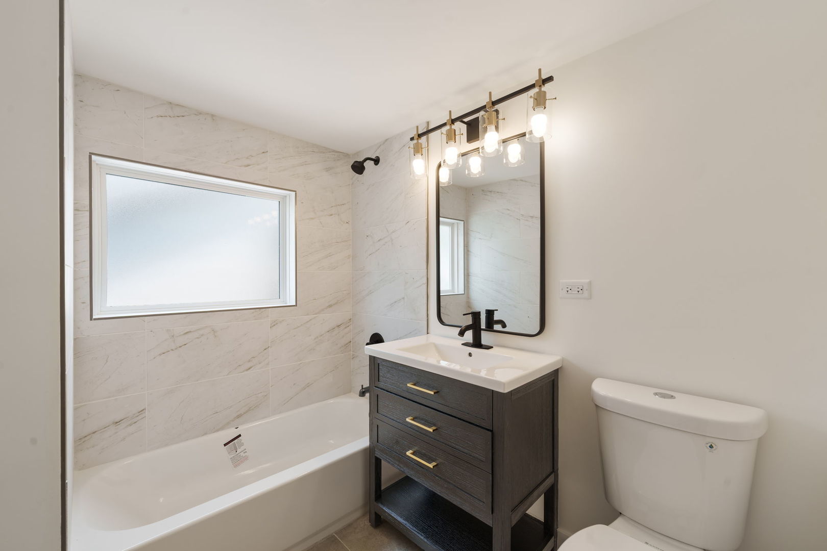 2733 Wesley Avenue Berwyn, IL 60402 - Photo 21 of 33 a bathroom with a bathtub shower sink vanity and toilet