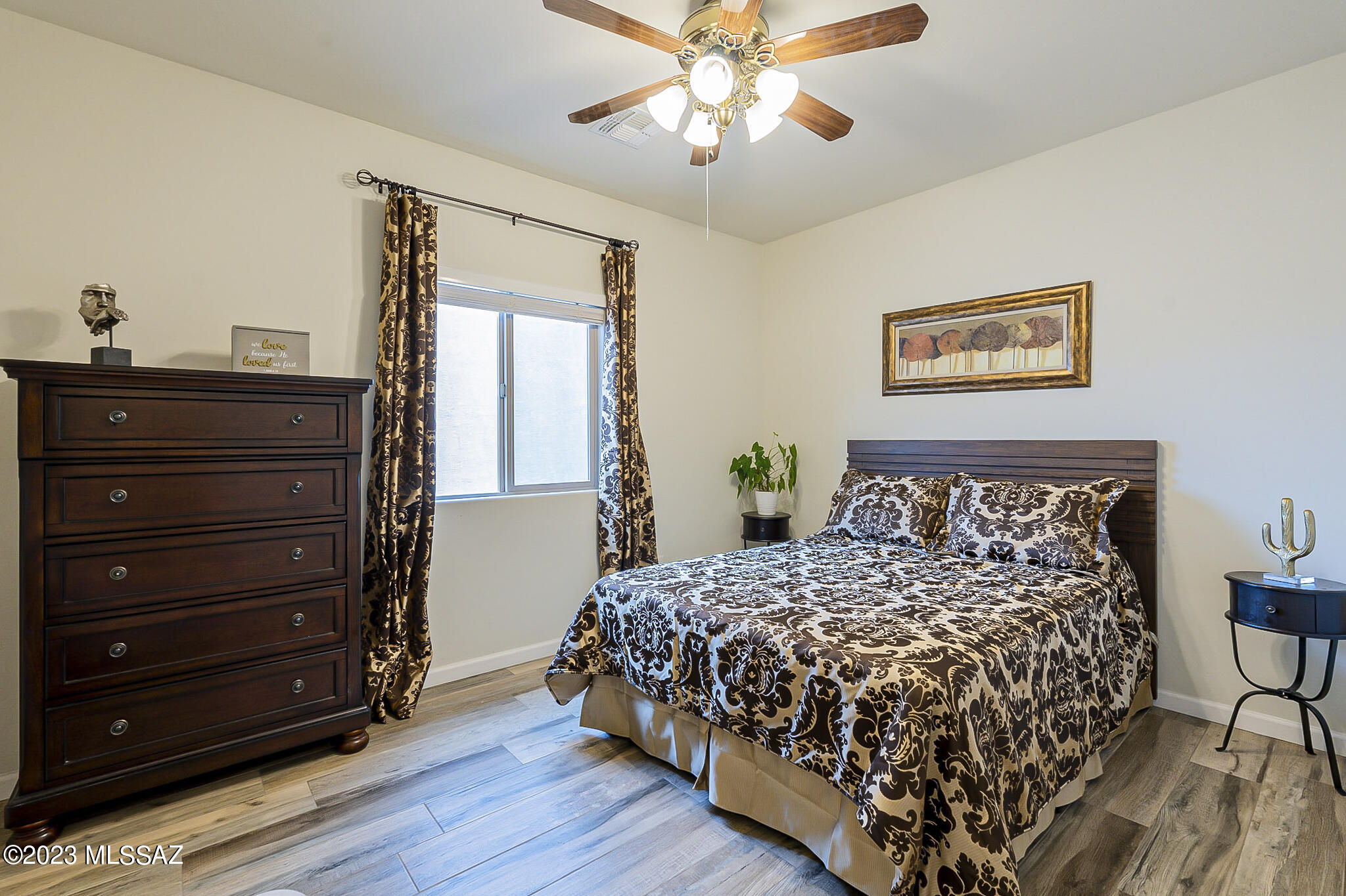 21311 East Founders Road Red Rock, AZ 85145 - Photo 12 of 20 a bedroom with a bed and a chandelier