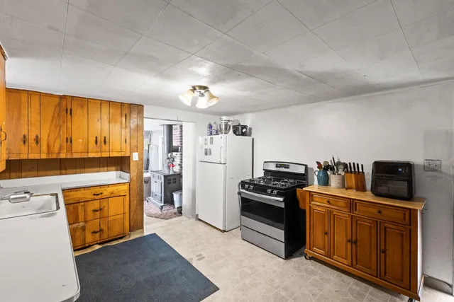 a kitchen with cabinets wooden floor and stainless steel appliances