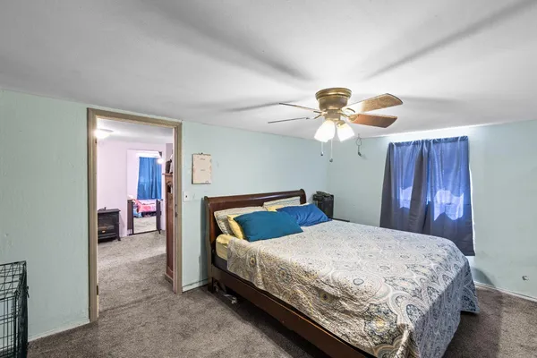 a bedroom with a bed and a chandelier