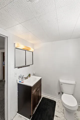 a bathroom with a sink toilet and mirror
