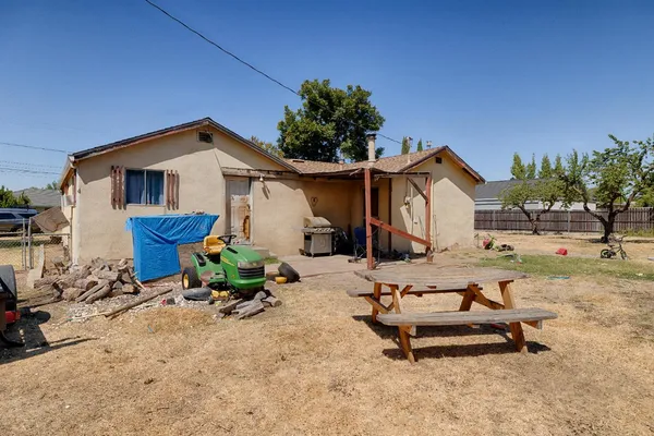 a view of backyard with a table and chairs