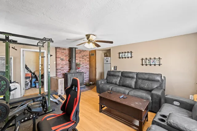 a living room with furniture a ceiling fan and a window