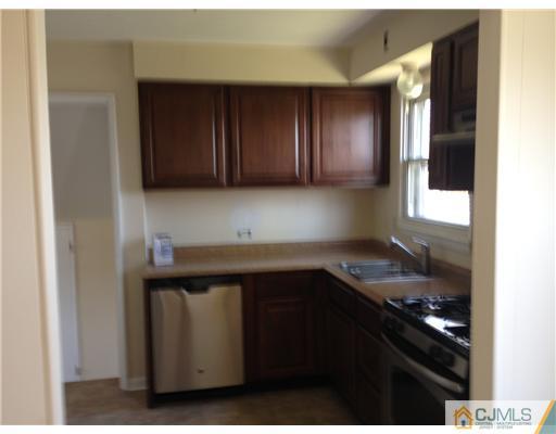 19 Wilshire Road Edison, NJ 08817 - Photo 2 of 7 a kitchen with a sink and cabinets