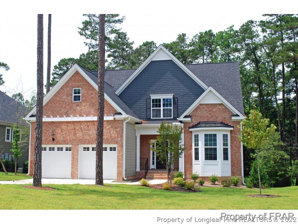 22 Spring Pond Lane Spring Lake, NC 28390 - Photo 1 of 35 a front view of a house with a yard