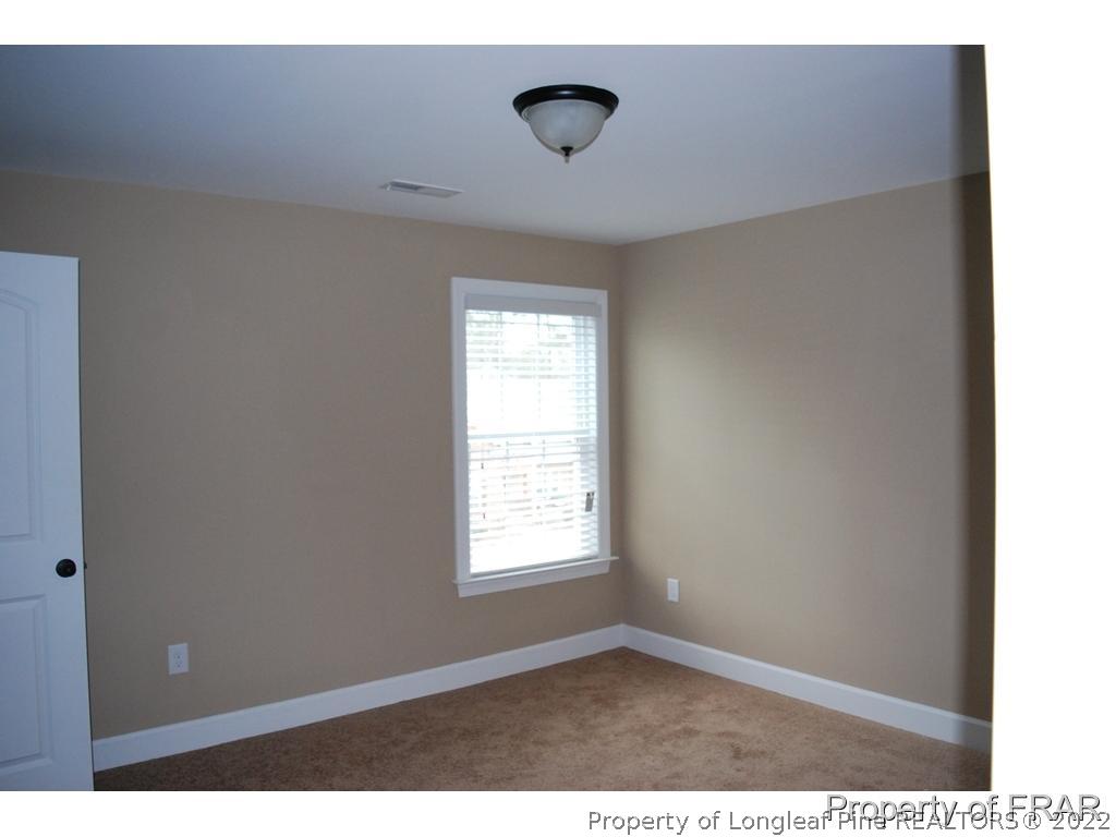 22 Spring Pond Lane Spring Lake, NC 28390 - Photo 20 of 35 a view of an empty room with window and closet