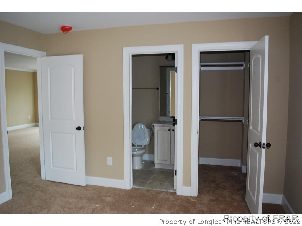22 Spring Pond Lane Spring Lake, NC 28390 - Photo 21 of 35 a living room with closet and wooden floor