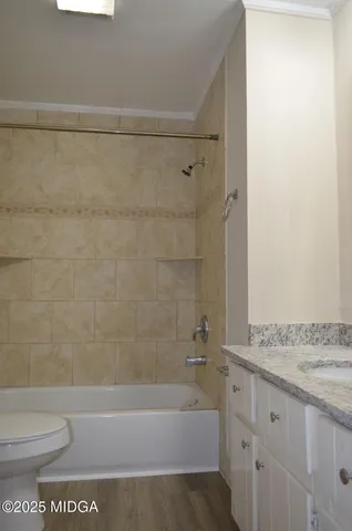 a view of a small space with wooden floor and a window