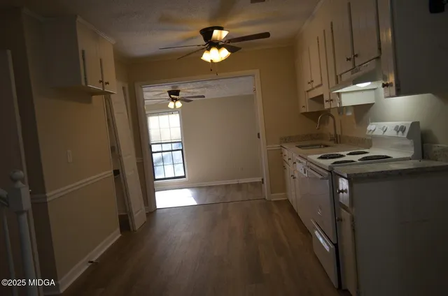 a view of a hallway with wooden floor and entryway