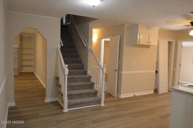 a kitchen with granite countertop white cabinets and white appliances