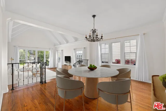 a view of a dining room with furniture wooden floor and chandelier