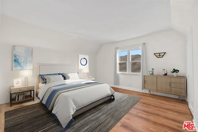 a bedroom with a large bed and a window