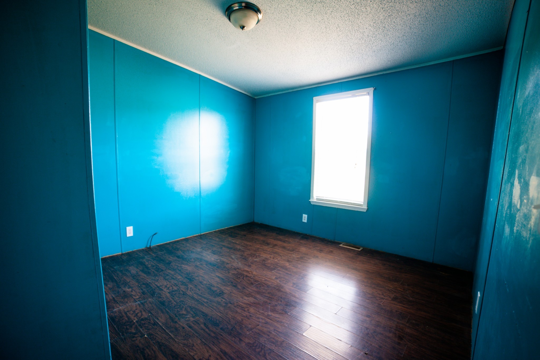 1606 Harpo Road Manchester, TN 37355 - Photo 11 of 27 an empty room with wooden floor and windows